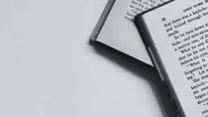 A black and white open book on a textured surface