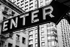 An abstract black & white photograph featuring a curved line and light reflections