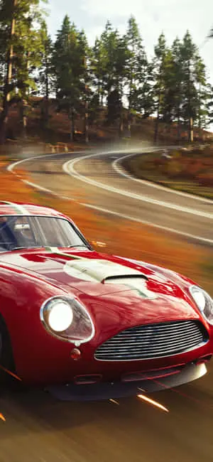 a red car driving down a road